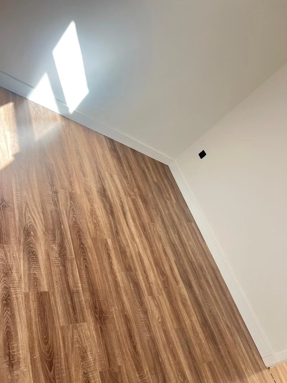 باركيه بنية اللون وجدار ابيض